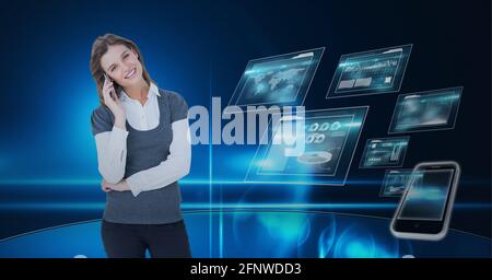 Composition of smiling businesswoman using smartphone over digital screens with data processing Stock Photo