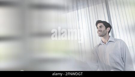 Composition of smiling businessman and colleague shaking hands in office with motion blur Stock Photo