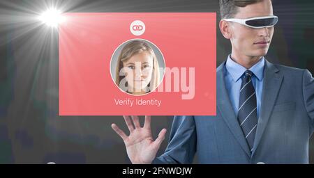 Composition of businessman in vr goggles using interface id verification screen Stock Photo