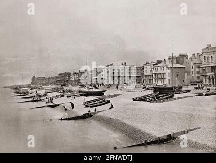 A late 19th Century view of the beach at Worthing, a large seaside town in West Sussex, England. Worthing had remained an agricultural and fishing hamlet for centuries until the arrival of wealthy visitors in the 1750s. The town expanded in the 19th Century, but was also a stronghold of smugglers, the site of rioting by the Skeleton Army in the 1880s and a writer's paradise - Oscar Wilde wrote the Importance of Being Earnest during his second visit. Stock Photo