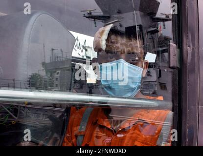 Mumbai, India. 19th May, 2021. A man wearing a face mask is seen inside a bus after being rescued by Indian Navy from Barge P305. The Indian Navy rescues people who were stranded aboard Barge P305 due to cyclone 'Tauktae'. (Photo by Ashish Vaishnav/SOPA Images/Sipa USA) Credit: Sipa USA/Alamy Live News Stock Photo