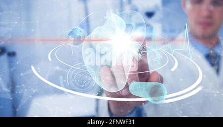Composition of male doctor touching screen with heart and medical data processing Stock Photo