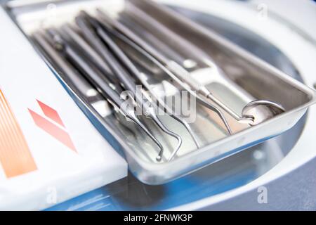 Different dental tools in the dental office. Dental chair instruments. Close-up dentist tools capture. Stock Photo