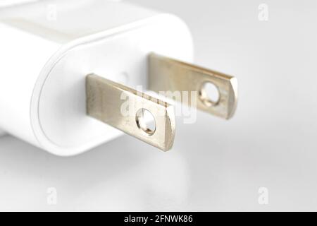 White charge adapter with US socket close up photo on white and silver background Stock Photo