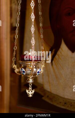 Icon lamp in front of icon in Orthodox Church. Indoors, day light Front view.