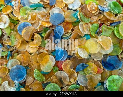 Macro photograph of a bunch of round slivers of colorful glass like rocks makes a pretty background or texture. Slight bokeh effect. Stock Photo