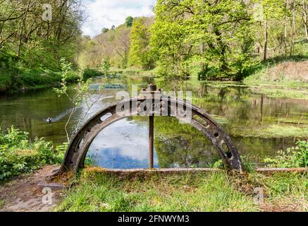 Old sluice gate on the trout pools of the River Bradford at Bradford Dale in the Derbyshire Peak DistrictUK  below the village of Youlgrave Stock Photo