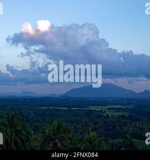 Tranquil fluffy cloud over the tropical mountain at sunrise in Thailand Stock Photo