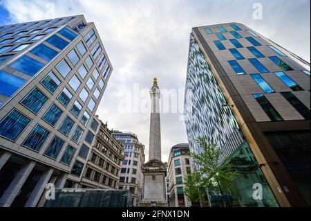 London, UK: The Monument to the Great Fire of London, usually called simply The Monument, is a Doric column located in the City of London. Stock Photo