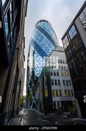 London, UK: Looking up at the Gherkin building in the City of London. View of the Gherkin or 30 St Mary Axe from Bury Street. Stock Photo
