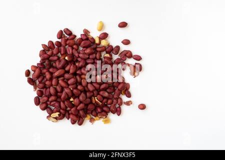 group of peeled peanuts isolated on white background, top view, pile of unpeeled peanuts close up, heap of peanuts with empty space for text Stock Photo