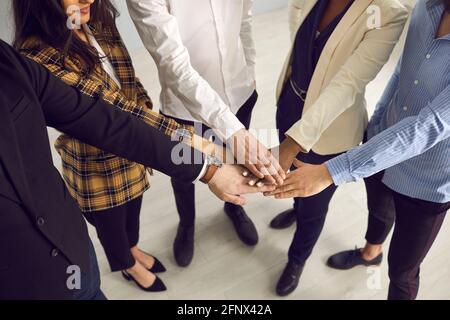 Multiethnic business team hands together stacking in circle midsection shot Stock Photo