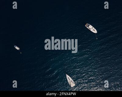 Aerial view of boats and yachts moored off the coast of Montenegro, deep blue Adriatic sea