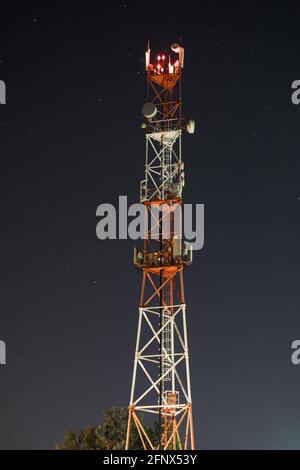 Towers for mobile communication systems 4g and 5g on the background of the starry sky. Cellular base station at night Stock Photo