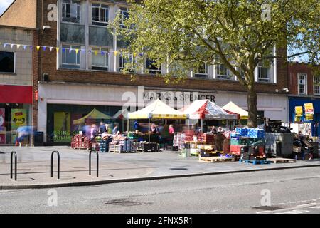 St Albans-UK - 19 May 2021 - People shopping and walking on busy retail high street with market stalls and shops Stock Photo