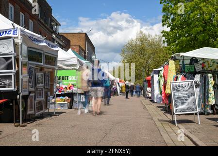 St Albans-UK - 19 May 2021 - People shopping and walking on busy retail high street with market stalls and shops Stock Photo