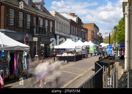 St Albans-UK - 19 May 2021 - People shopping and walking on busy retail high street with market stalls and shops Stock Photo