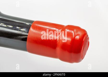 red plastic stopper on a wine bottle neck macro Stock Photo