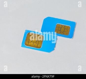 used scratched blue mobile phone sim cards macro on white Stock Photo