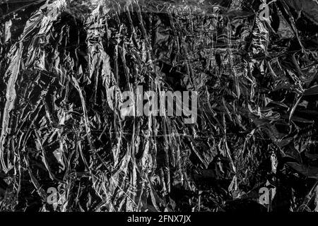 Black abstract grunge plastic material. Wrinkled texture. Dark background Stock Photo