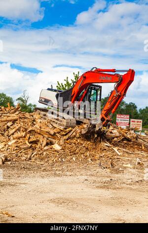 Cleaning up driftwood along the south arm of the Fraser River near Steveston in British Columbia Canada Stock Photo