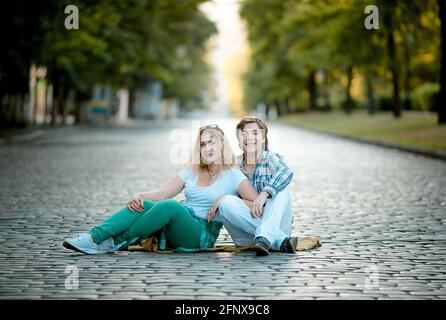 Dnepropetrovsk, Ukraine - 07.16.2017: Happy couple of lovers on a cobblestone pavement on a city street. Stock Photo