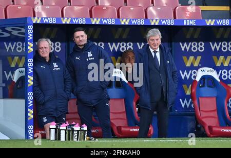 Crystal Palace manager Roy Hodgson (right), assistant Ray Lewington (left) and first team coach Dave Reddington (centre) in the dugout during the Premier League match at Selhurst Park, London. Picture date: Wednesday May 19, 2021. Stock Photo