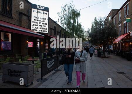 Clapham, London, 19 May 2021: the audience leave the Clapham Picturehouse cinema after it's first day of opening since it was closed in October due to the coronavirus pandemic. Many film releases have been delayed by months or even over a year. Indoor leisure activities have only been allowed since the start of this week. Customers must wear face masks and screenings are seated at half their usual capacity. Anna Watson/Alamy Live News Stock Photo