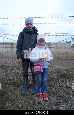 Children on the background of barbed wire. Lack of freedom, hunger, poverty ... Stock Photo