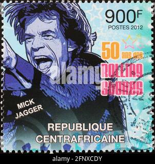 Portrait of Mick Jagger in concert on postage stamp Stock Photo