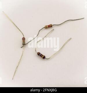 miniature resistors on white background. Passive two terminal electrical components Stock Photo