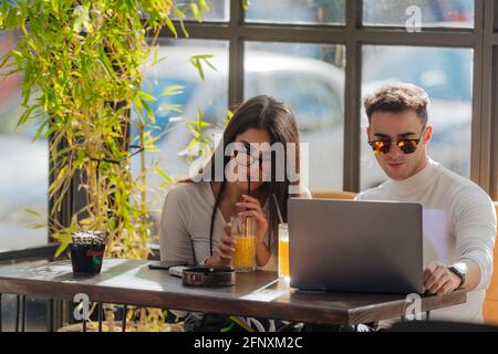 Co-workers spending time together on a break while working on a project on a lovely sunny day. Stock Photo