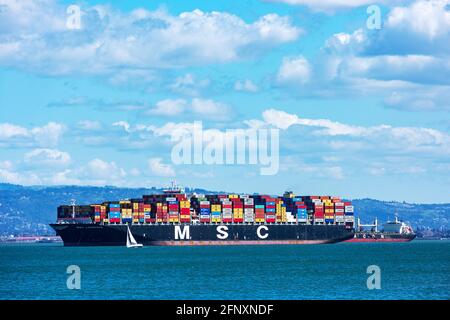 MSC Laurence container ship fully loaded with containers is anchored in San Francisco Bay waiting to dock at the Port of Oakland. - Oakland, Californi Stock Photo