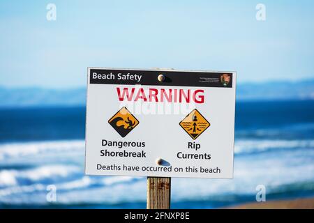 Beach safety warning sign informs visitors about dangerous shorebreak ...