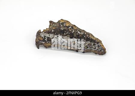 Triangle Piece of meteorite on white background with pattern Stock Photo