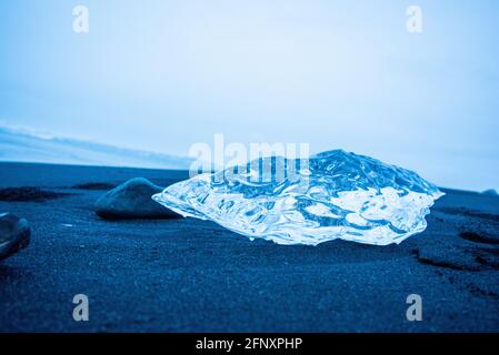 Close up of a piece of glacier beached in Iceland shiny beautiful magical diamond like crystal frozen Stock Photo