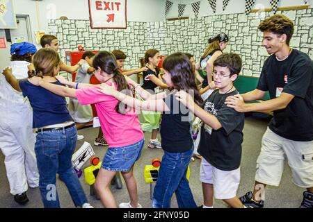 Miami Florida,Gateway Baptist Church Vacation Bible School,members students dance dancing conga line boys girls friends Hispanic, Stock Photo