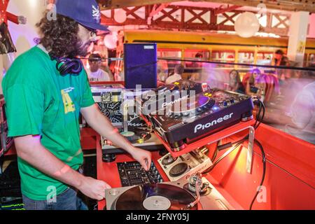 Miami Florida,The Pawn Shop night club night,dee jay dj disc jockey playing music records dance,sound system man male, Stock Photo