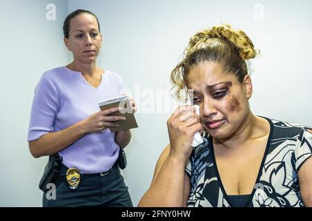 North Miami Beach Florida,Police Department,Hispanic woman female acting abuse victim wearing makeup female detective,interviews interviewing, Stock Photo