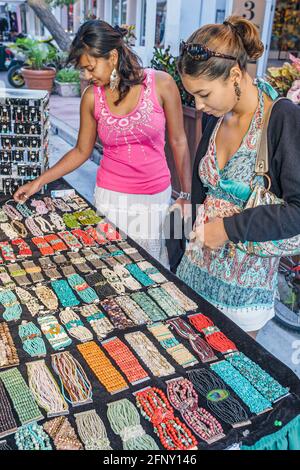Miami Beach Florida,Espanola Way stalls booth vendor women shopping,marketplace buying selling Hispanic Asian looking woman female jewelry jewellery, Stock Photo