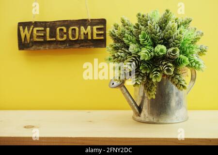 Welcome sign Hanging on yellow background Stock Photo