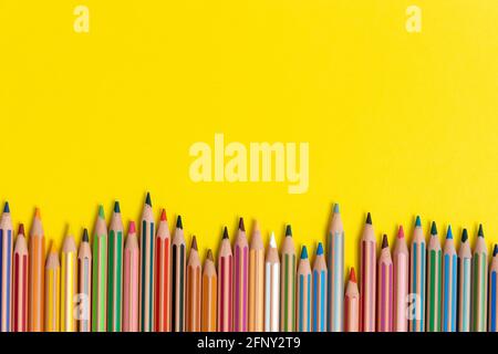 Coloring pencils isolated on yellow background close up concept with copy space for text Stock Photo