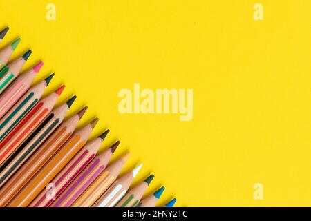 Coloring pencils isolated on yellow background close up concept with copy space for text Stock Photo