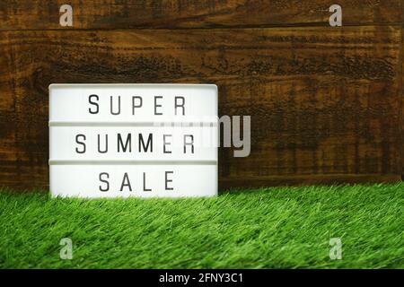 Summer Sale text in light box on wooden background Stock Photo