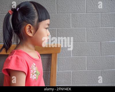 Profile image of little girl, long black hair.
