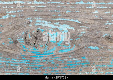 Old wooden abstract background texture surface with peeling blue paint. Close up of an old outdoor table in the park. Stock Photo