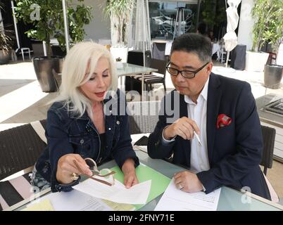 Beverly Hills, California, USA. 19th May, 2021. Princess Karen Cantrell and TV host Joey Zhou during a meeting to announce the upcoming vernissage (private viewing) event for Los Angeles Beverly Arts (LABA) artist Jiannan Huang called “Inextricably Linked:  The Art of Jiannan Huang” to be held  on May 26th in Beverly Hills, California.  Credit: Sheri Determan Stock Photo