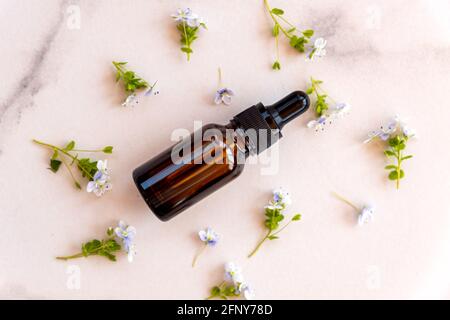 Cosmetic bottle, face serum, on marble background. Advertising Beauty salon, face care. Healthy skin without wrinkles concept. Stock Photo