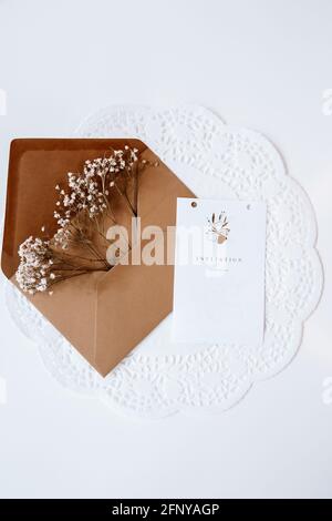 Brown envelop filled with flowers for wedding, birthday, or graduation. Mood and lifestyle pictures for Instagram and Pinterest Stock Photo