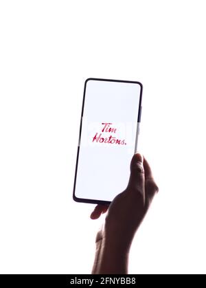 Assam, india - May 18, 2021 : Tim Hortons logo on phone screen stock image. Stock Photo